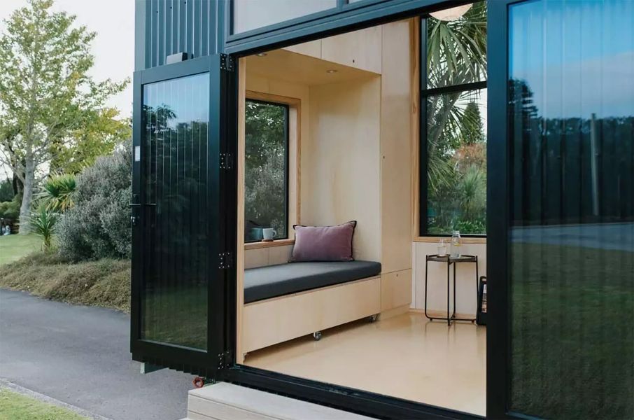 The sizeable windows of the Ohairu net-zero tiny house help widen the interior.